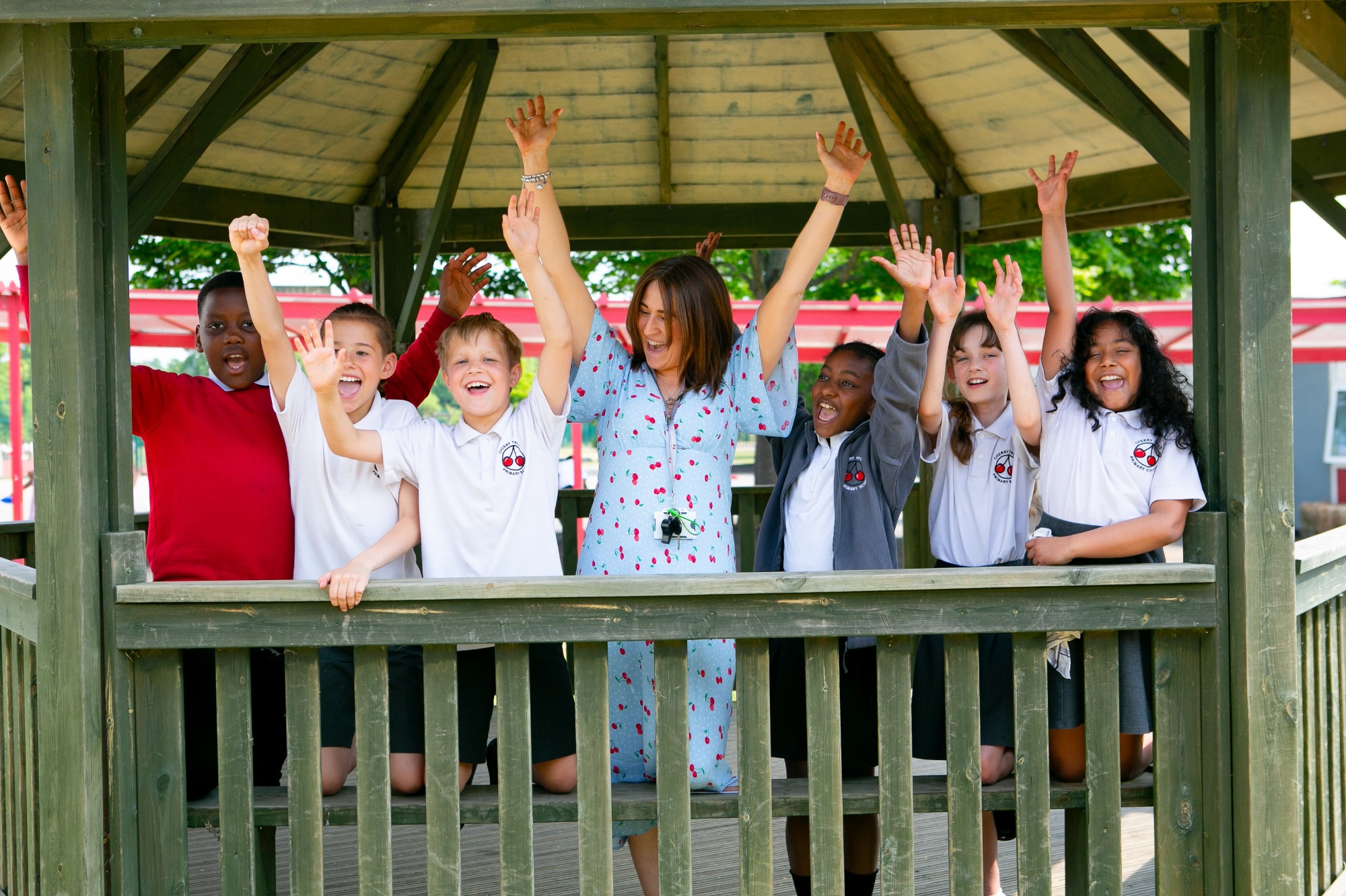 pupils & the deputy head teacher cheer together in the outdoor classroom